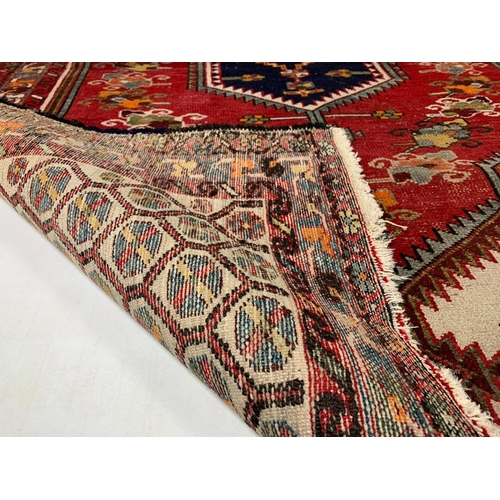 1009 - Middle Eastern hand knotted rug, 202cm x 131cm