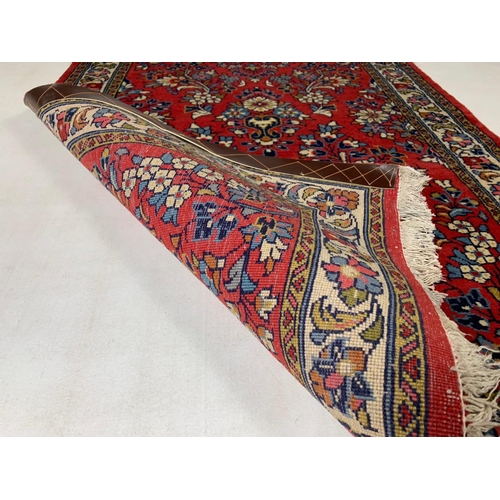 1014 - Middle Eastern hand knotted wool runner, 212cm x 82cm