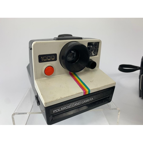 154 - 3 vintage polaroid cameras with a vintage Kodak camera