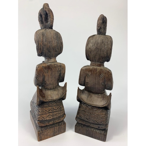 232 - Pair of rosewood deity figures. Biggest figure is 22cm