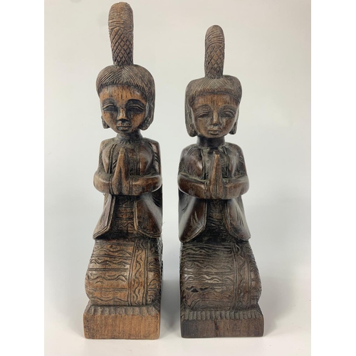 232 - Pair of rosewood deity figures. Biggest figure is 22cm