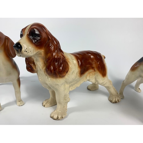 240 - 3 pottery dogs, 1 by Coopercraft. 27cm.