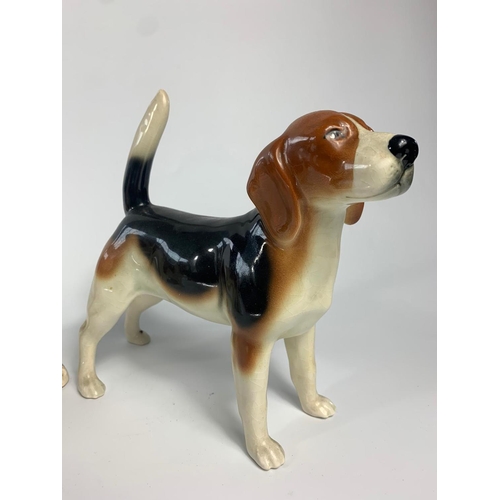 240 - 3 pottery dogs, 1 by Coopercraft. 27cm.