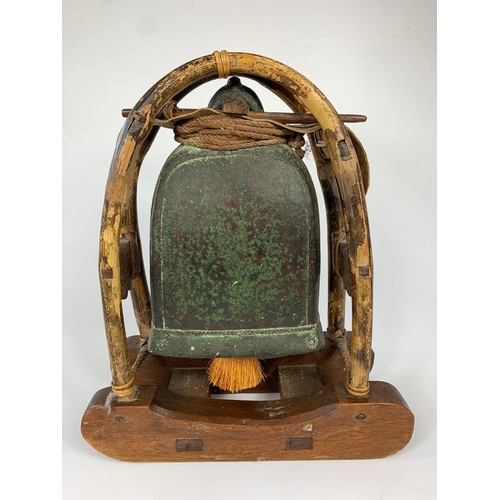 46 - 19th century bronze temple bell on wooden stand, 38cm