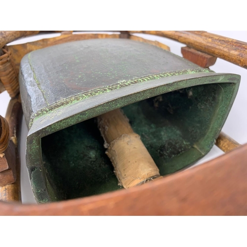 46 - 19th century bronze temple bell on wooden stand, 38cm