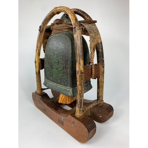 46 - 19th century bronze temple bell on wooden stand, 38cm