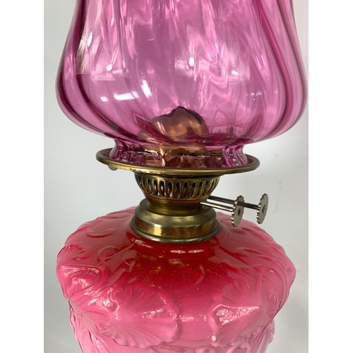 16 - Large Victorian style ruby oil lamp with Corinthian style pillar, 83cm