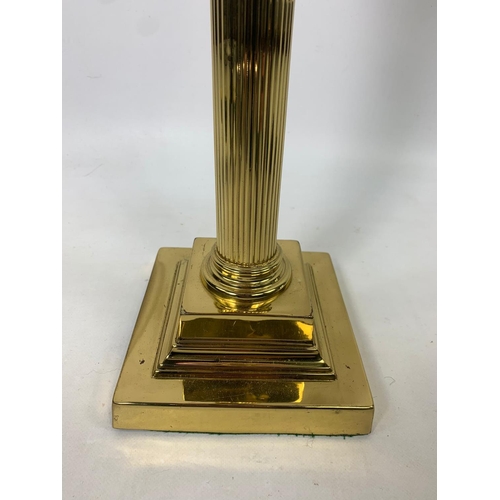 16 - Large Victorian style ruby oil lamp with Corinthian style pillar, 83cm