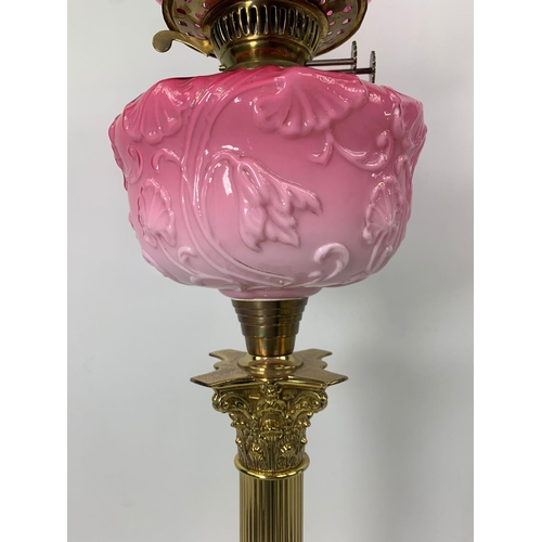 16 - Large Victorian style ruby oil lamp with Corinthian style pillar, 83cm