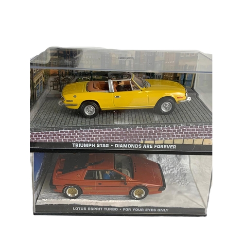 128 - Quantity of 007 James Bond model cars in cases. 14cm