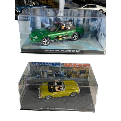 128 - Quantity of 007 James Bond model cars in cases. 14cm