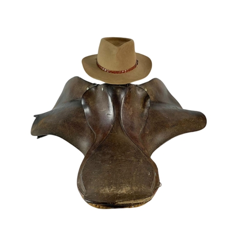 182 - Leather horse saddle and an Akubra hat.