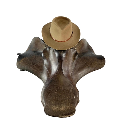 182 - Leather horse saddle and an Akubra hat.