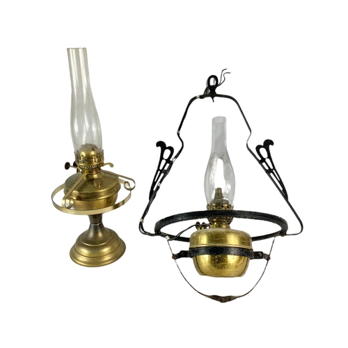 217 - 2 vintage brass oil lamps. 1 electrified. 61cm. 52cm