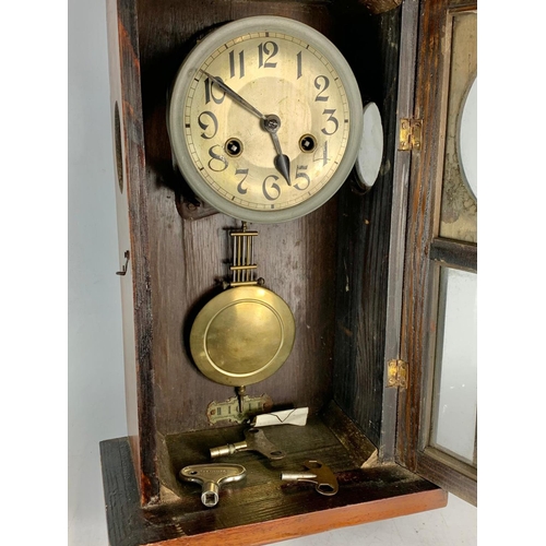 230 - 1930’s vintage wall clock. With keys and pendulum. 30/49cm