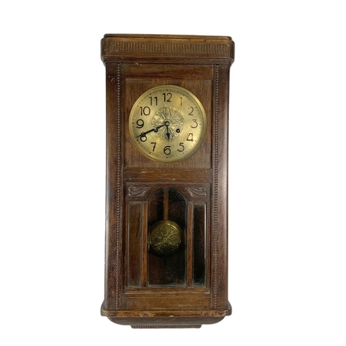 257 - 1930’s oak case wall clock. 74cm