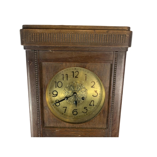 257 - 1930’s oak case wall clock. 74cm