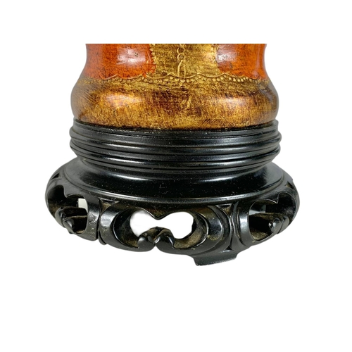 269 - Ornate Chinese style lamp on a carved wooden base. 71cm including shade.