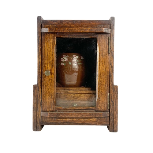 67 - 1920’s oak smokers cabinet. With pottery humidor. 20.5/16/28cm