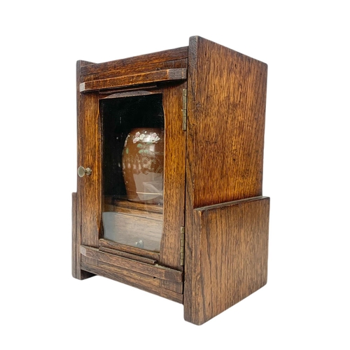 67 - 1920’s oak smokers cabinet. With pottery humidor. 20.5/16/28cm