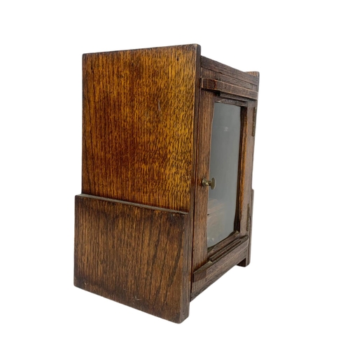 67 - 1920’s oak smokers cabinet. With pottery humidor. 20.5/16/28cm