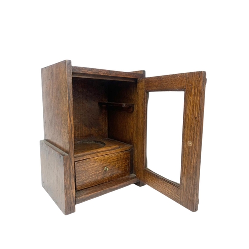 67 - 1920’s oak smokers cabinet. With pottery humidor. 20.5/16/28cm