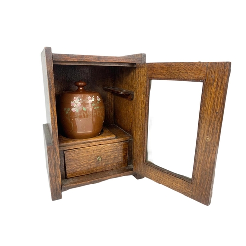 67 - 1920’s oak smokers cabinet. With pottery humidor. 20.5/16/28cm