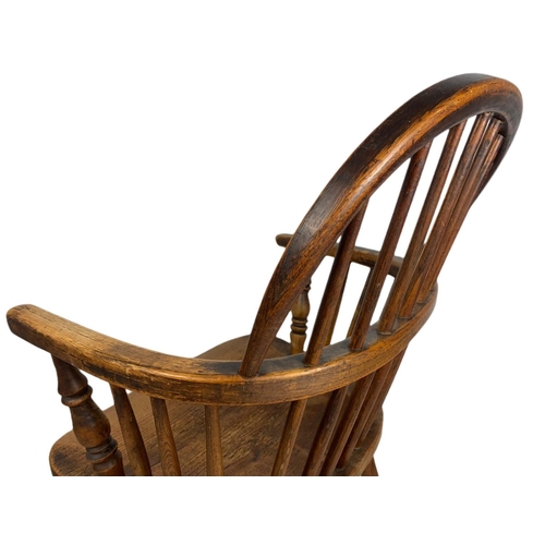 855 - Mid 19th century Windsor armchair. 93cm