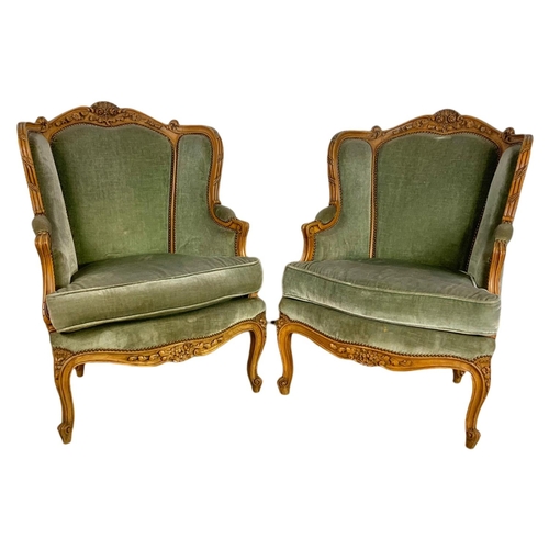 875 - Pair of early 20th century French carved walnut wingback armchairs. 70/75/101cm