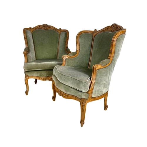 875 - Pair of early 20th century French carved walnut wingback armchairs. 70/75/101cm