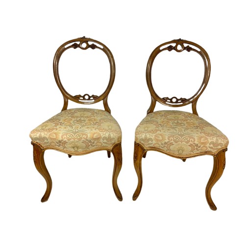 856 - Pair of Victorian walnut balloon back side chairs.