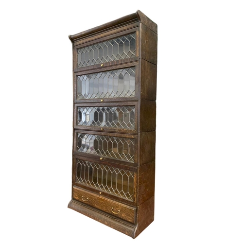 877 - Large Edwardian stacking bookcase with drawer by Gumm. 86.5/36/188cm