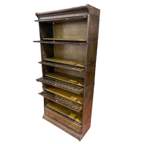 877 - Large Edwardian stacking bookcase with drawer by Gumm. 86.5/36/188cm