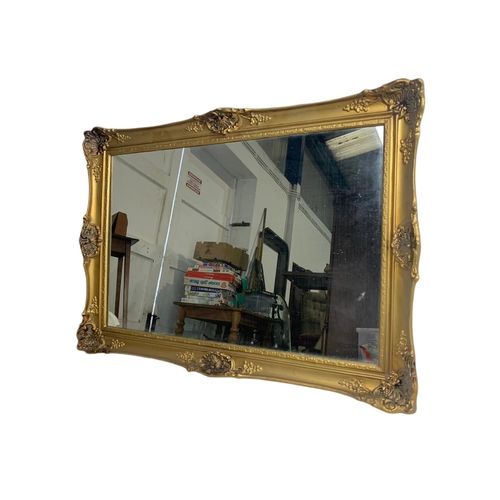 923 - Ornate gilt framed mirror. Plastic frame. 69/56cm