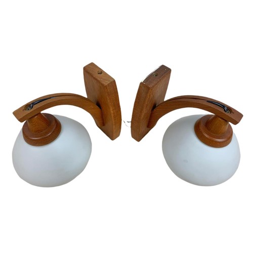 357 - Pair of teak mid century wall lights with glass shades. 20/19cm