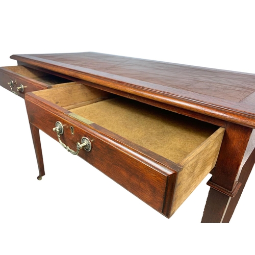 1010 - Edwardian oak leather top 2 drawer writing table. 107/49/76.5c