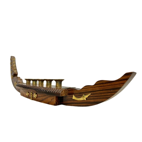 156a - Vintage rosewood and brass candle holder in the shape of a gondola. 52cm