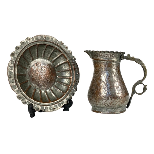 99a - 19th century Indian copper jug and dish. 20.5cm.