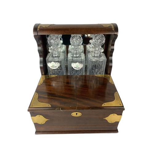 501 - Victorian style brass bound tantalus with 3 Crystal decanter and 6 crystal glasses. 36/34/38cm