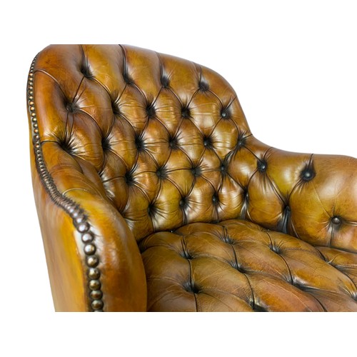 910 - Vintage Victorian style deep button leather swivel chair.