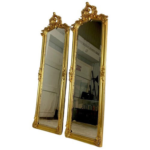 1028 - Pair of tall ornate gilt framed 18th century style mirrors. 53/168cm