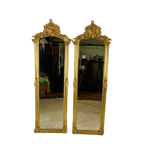 1028 - Pair of tall ornate gilt framed 18th century style mirrors. 53/168cm