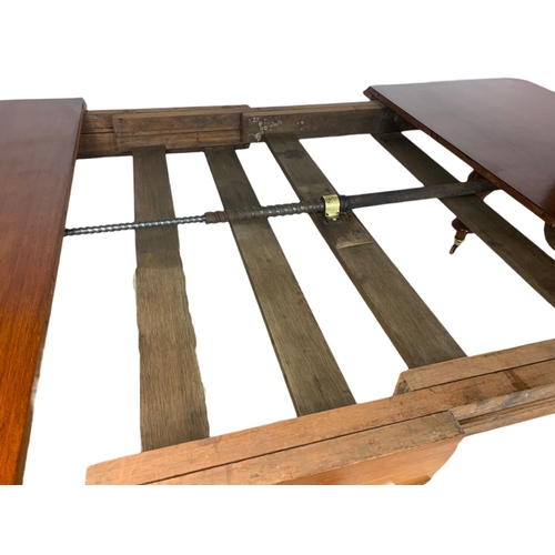 1108 - Large mid Victorian mahogany 2 leaf extendable dining table, with winder. Fully extended 240/137/76c... 