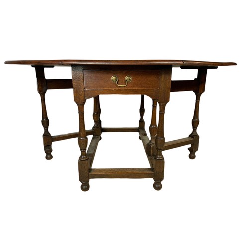 1122 - Early 20th century oak drop leaf table with drawer. Extended 148/112/73