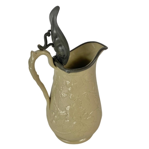 16 - 19th century pottery jug with pewter top. 24cm