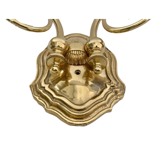 194 - Pair of heavy brass wall lights. 43/28cm