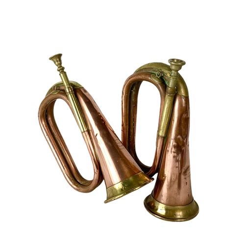 27 - Pair of early 20th century brass and copper bugles. 29cm