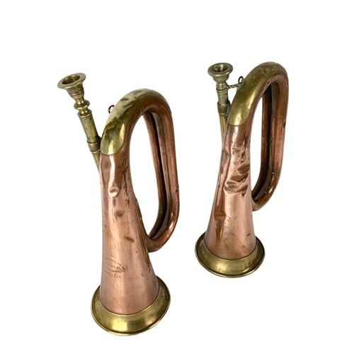 27 - Pair of early 20th century brass and copper bugles. 29cm