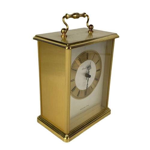 42 - Brass mantle clock, pair of vintage candle sticks and 4 piece of brassware. Clock 15x20cm