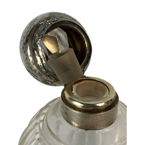 657 - Early 20th century sterling silver topped scent bottle. 13cm